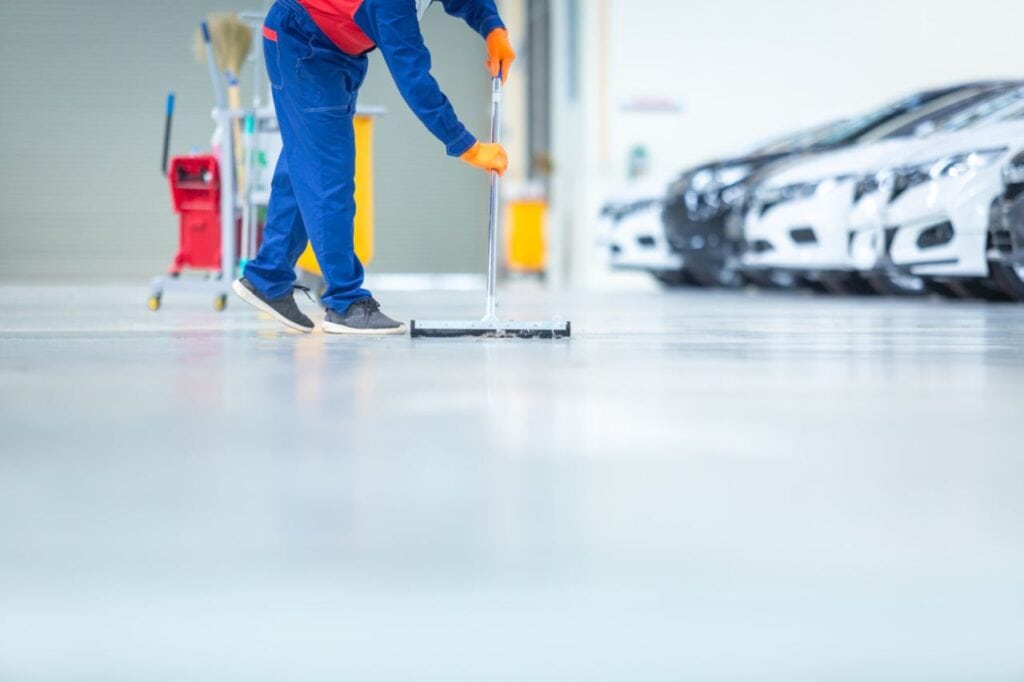 car mechanic repair service center cleaning using mops roll water from epoxy floor car repair service center (1)